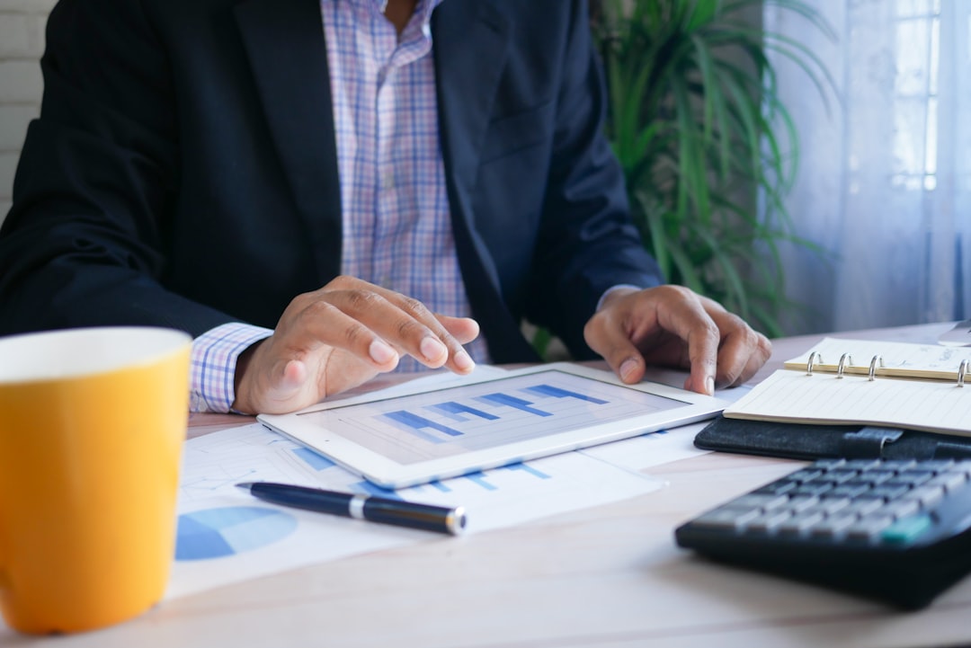 Do Business Term Loans Require Collateral? Business professional reviewing financial information on a tablet