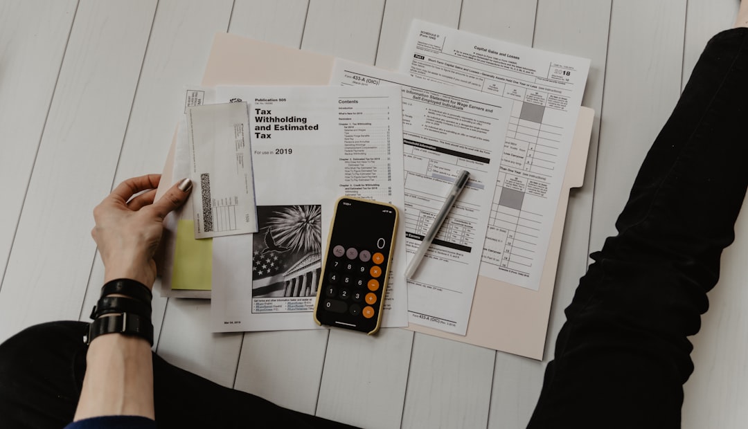 How Long Does a Merchant Cash Advance Take to Repay? Business owner reviewing cash flow documents with a calculator