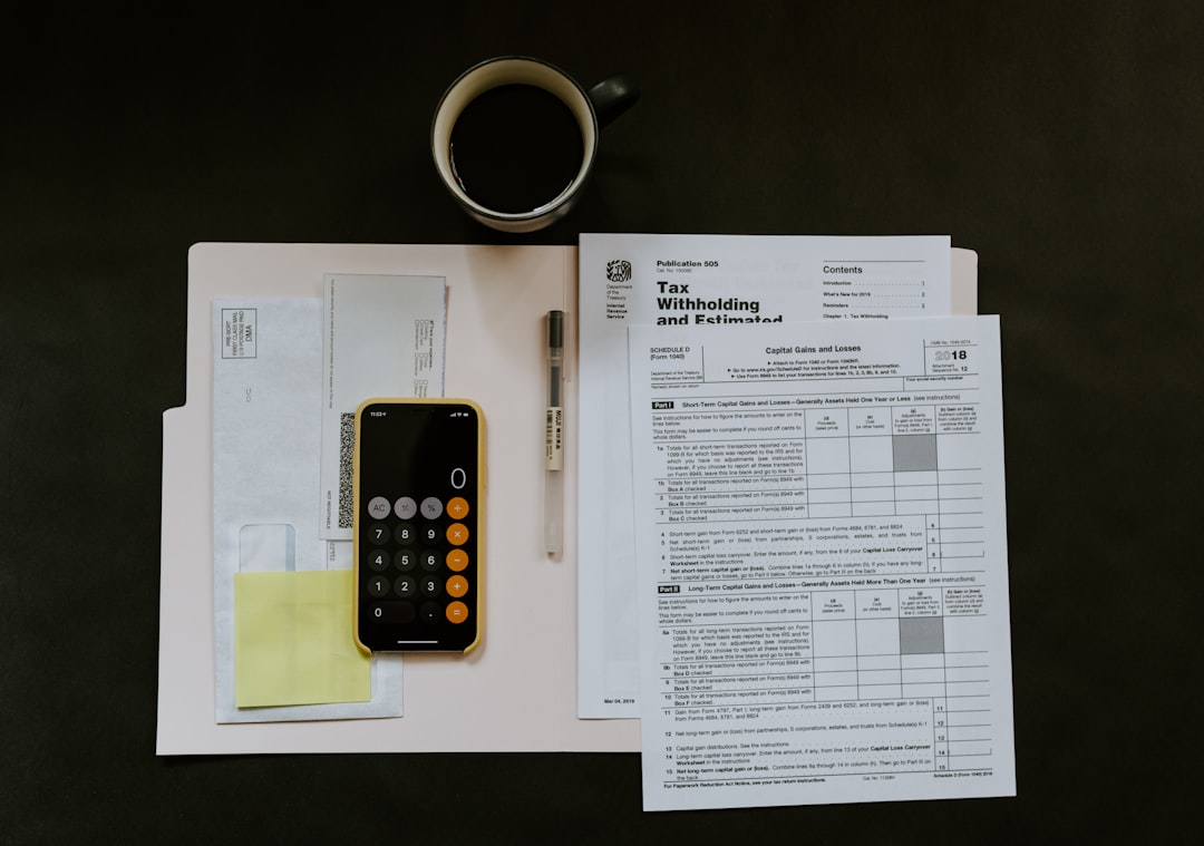 MCA Broker vs. Direct Funder: What Should a Business Owner Know? Calculator, documents, and smartphone used to compare business funding